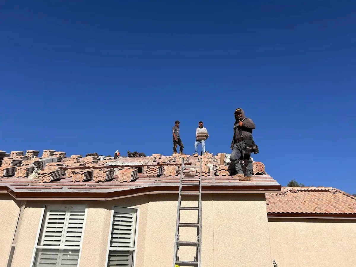 Roofer bedding ridge tiles in mortar